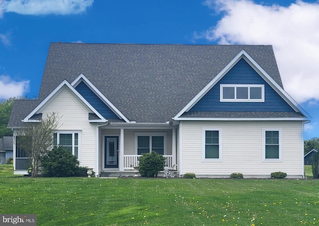 back of property with a porch and a yard