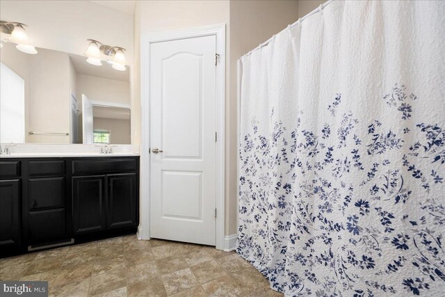 bathroom featuring tile patterned flooring and vanity