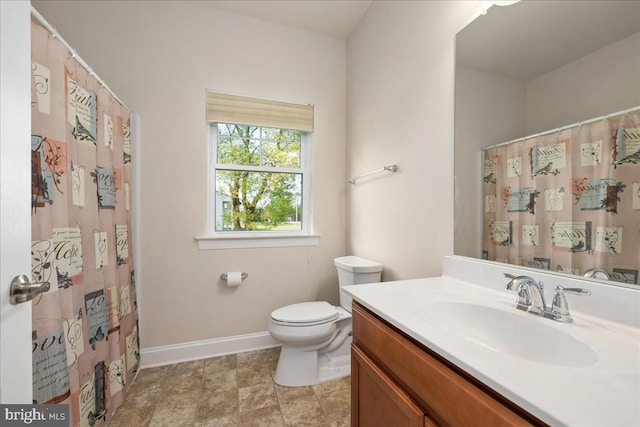 bathroom featuring tile patterned flooring, toilet, and vanity