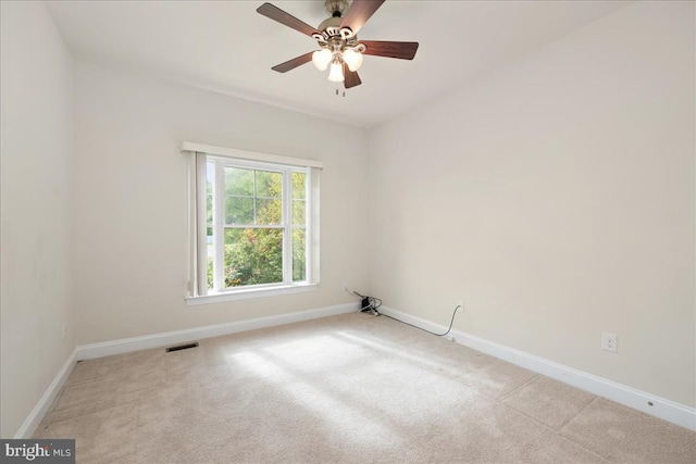 carpeted spare room with ceiling fan