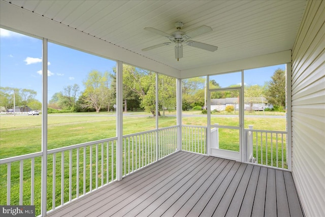 unfurnished sunroom with ceiling fan and plenty of natural light