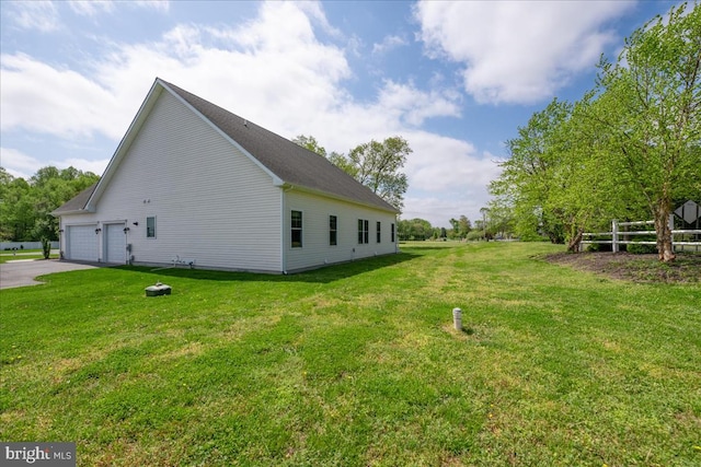 view of property exterior with a garage and a lawn