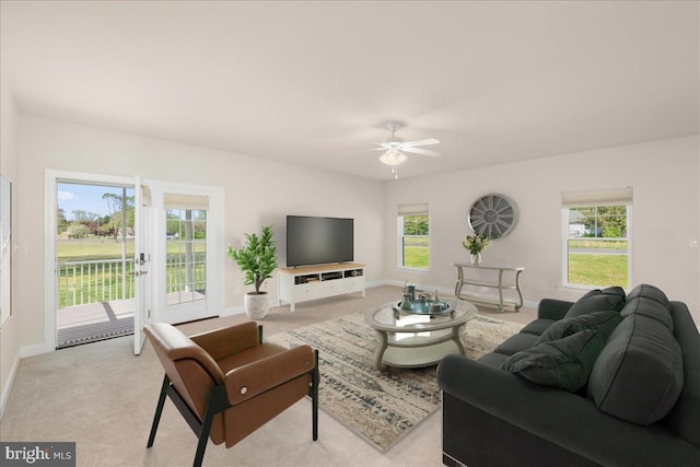 carpeted living room featuring ceiling fan