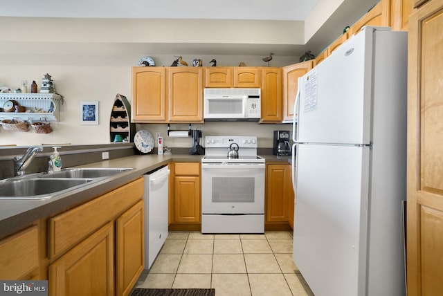 kitchen featuring light tile flooring, white appliances, and sink