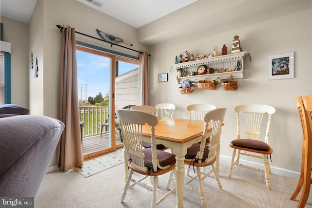 dining space with light colored carpet