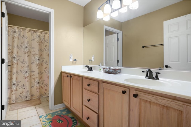 bathroom with oversized vanity, tile floors, and double sink