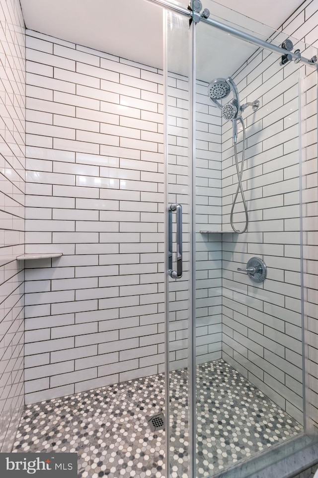 bathroom with a shower with shower door