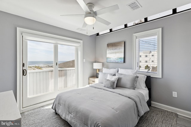 bedroom with dark hardwood / wood-style floors and ceiling fan