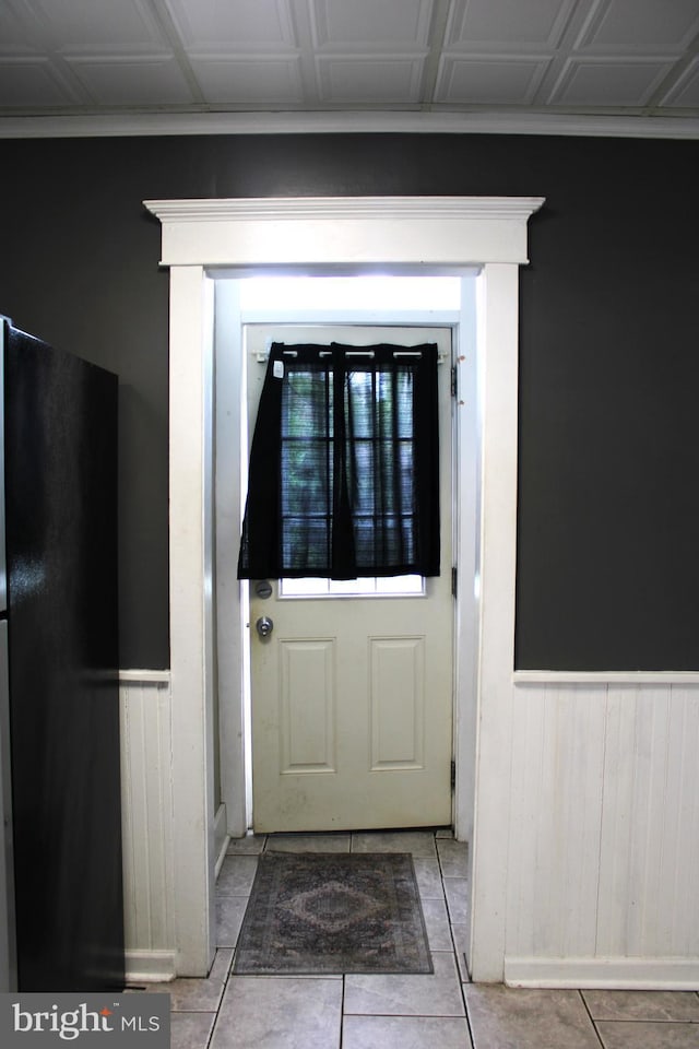 doorway to outside featuring light tile patterned flooring