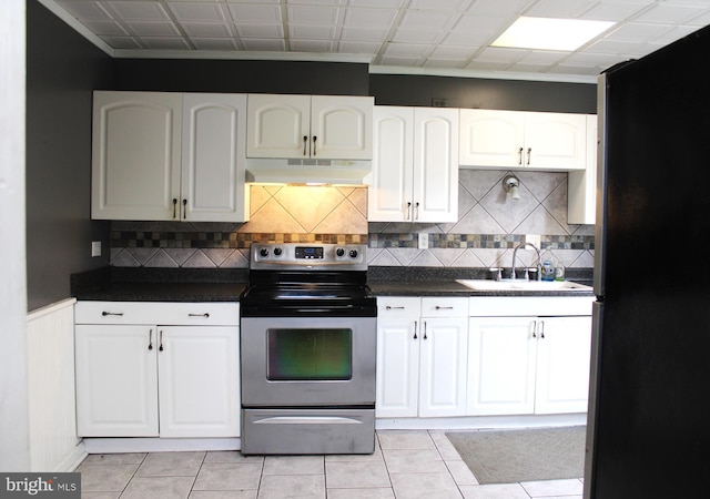 kitchen featuring white cabinetry, appliances with stainless steel finishes, sink, and light tile patterned flooring