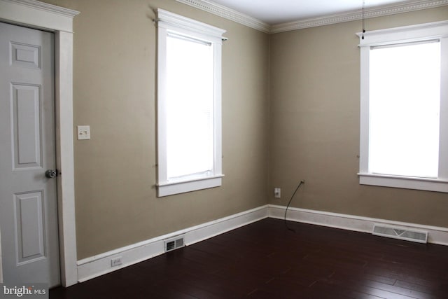 spare room with wood-type flooring and crown molding