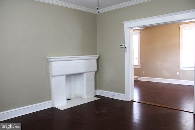 unfurnished living room featuring crown molding, wood-type flooring, and a healthy amount of sunlight