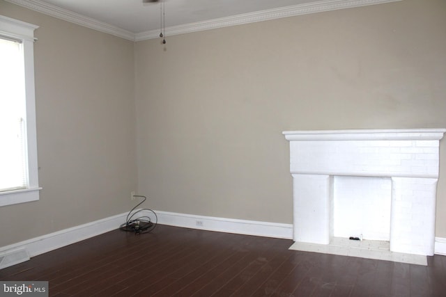 empty room with ornamental molding and dark wood-type flooring