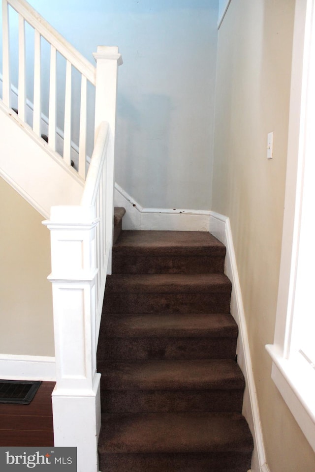 stairway featuring hardwood / wood-style floors