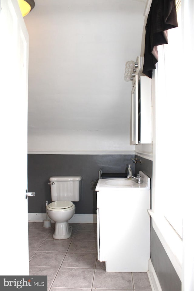 bathroom with vanity, tile patterned flooring, and toilet