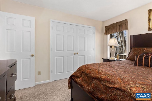 bedroom featuring light carpet and a closet