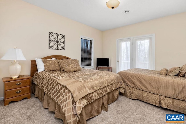 bedroom with light colored carpet