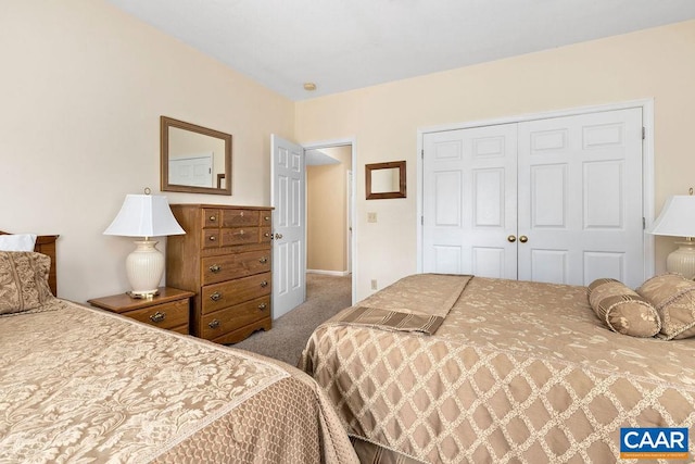 bedroom with a closet and dark carpet