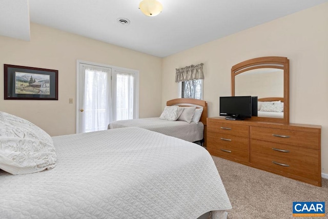 carpeted bedroom featuring multiple windows