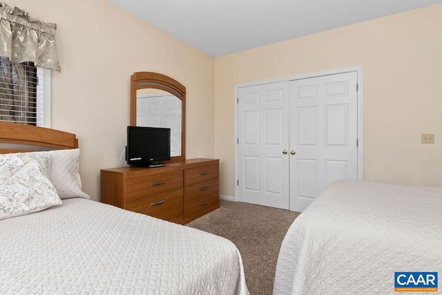 bedroom featuring a closet and dark colored carpet