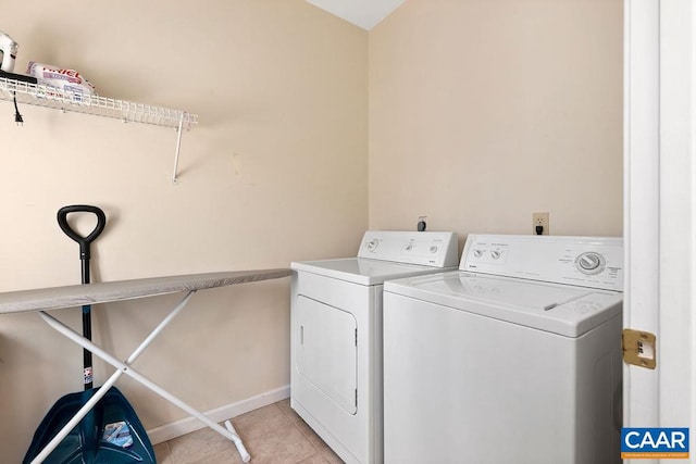 laundry area featuring hookup for an electric dryer, light tile floors, and separate washer and dryer