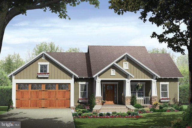 craftsman house with a garage, covered porch, and a front lawn