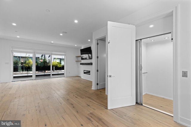 unfurnished living room featuring light wood-type flooring