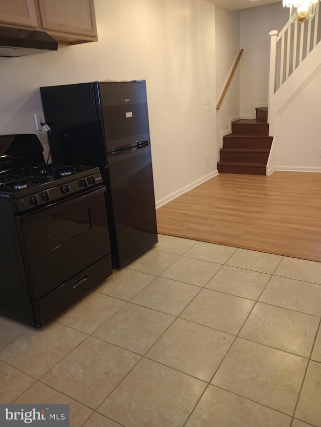 kitchen with gas range and light tile flooring