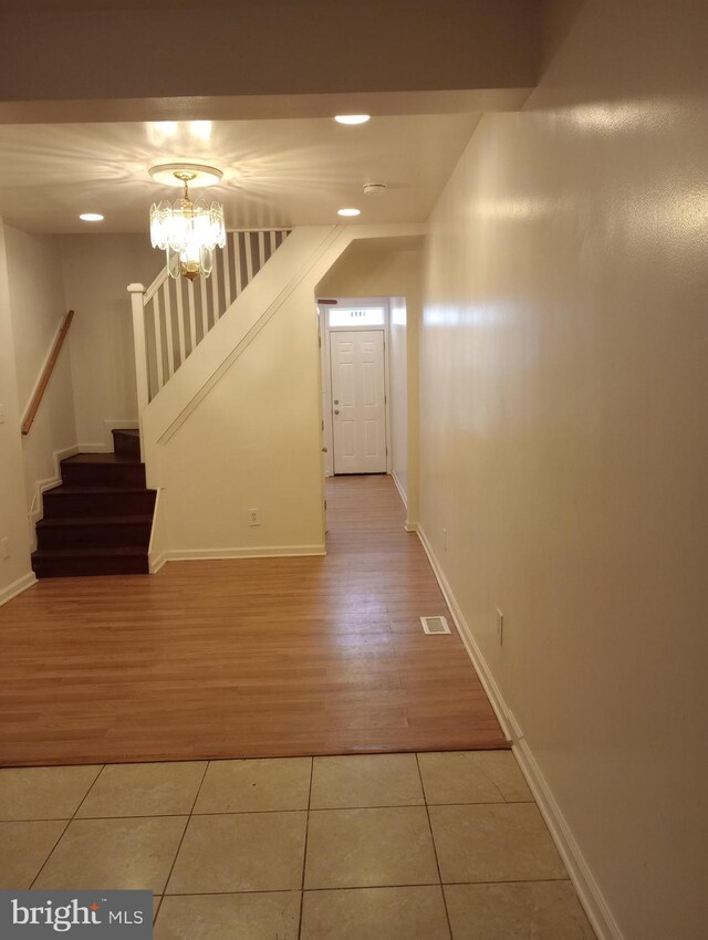 interior space with light hardwood / wood-style floors and an inviting chandelier