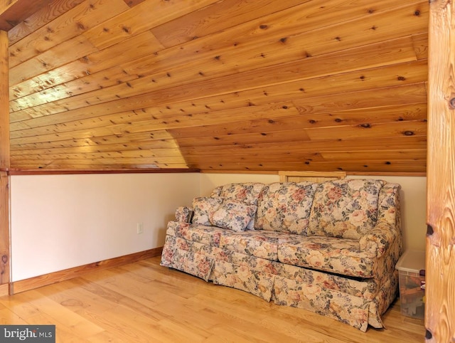 living area featuring wooden ceiling, vaulted ceiling, and light wood-type flooring