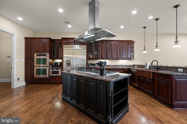 kitchen with dark hardwood / wood-style floors, island exhaust hood, pendant lighting, a kitchen island, and appliances with stainless steel finishes