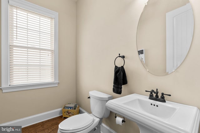 bathroom with a wealth of natural light, sink, hardwood / wood-style floors, and toilet