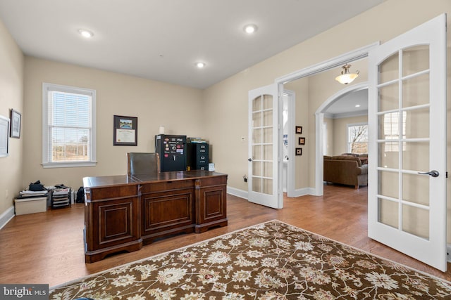 office area featuring french doors, a healthy amount of sunlight, and wood-type flooring