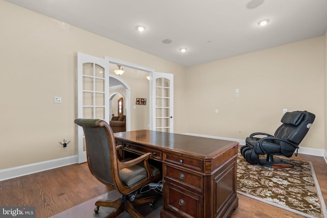 home office featuring dark hardwood / wood-style flooring and french doors