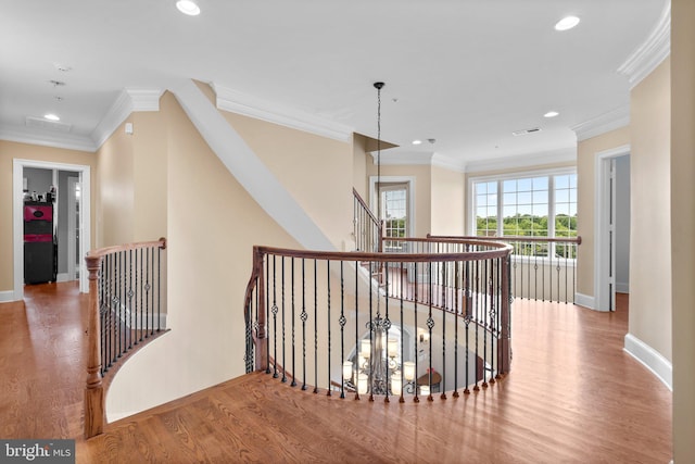 hall featuring hardwood / wood-style flooring and crown molding