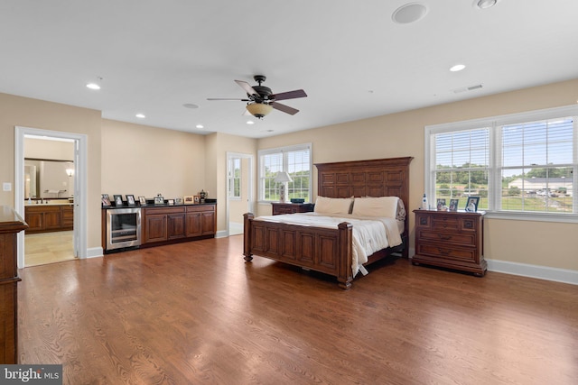 bedroom with multiple windows, ceiling fan, wood-type flooring, and wine cooler