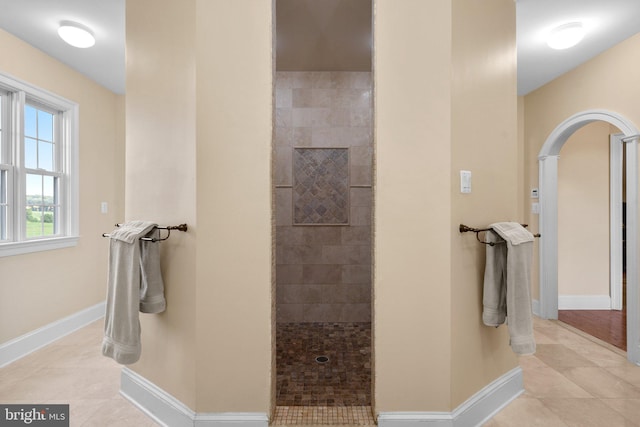 bathroom featuring tile patterned floors and a tile shower