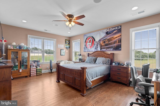 bedroom with ceiling fan and light wood-type flooring