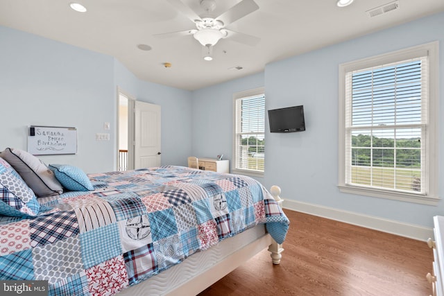 bedroom featuring hardwood / wood-style flooring and ceiling fan