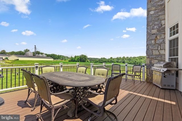 wooden deck featuring a grill