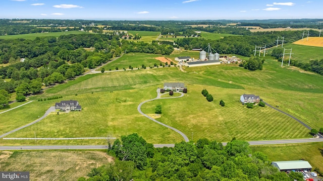 birds eye view of property with a rural view