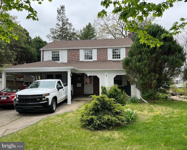 view of front facade featuring a carport and a front yard