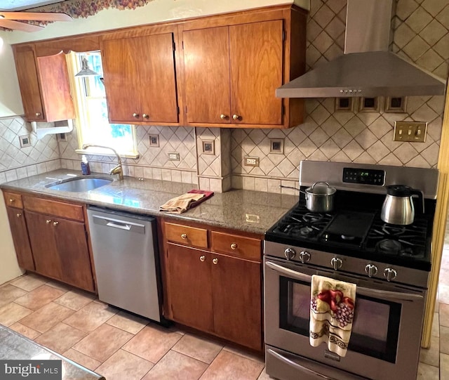 kitchen with backsplash, sink, wall chimney exhaust hood, and stainless steel appliances