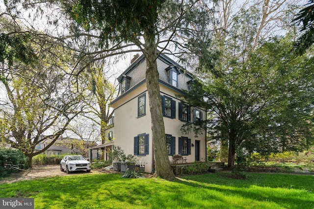 view of property exterior featuring a lawn