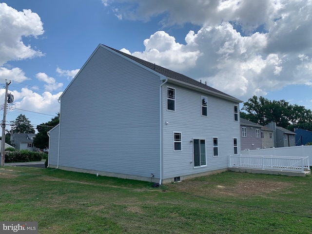 back of house with a lawn