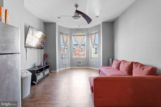 sitting room with hardwood / wood-style floors and ceiling fan