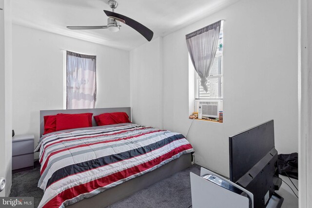 bedroom with ceiling fan and dark carpet