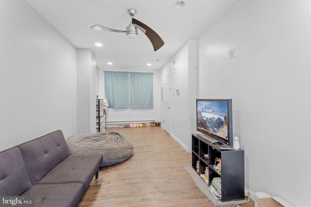 living room featuring light hardwood / wood-style floors and ceiling fan