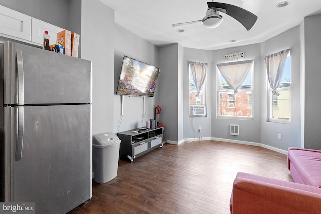 living area featuring dark hardwood / wood-style flooring and ceiling fan