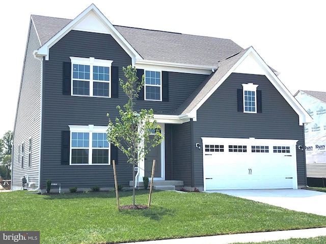 view of front of home featuring a front lawn and a garage